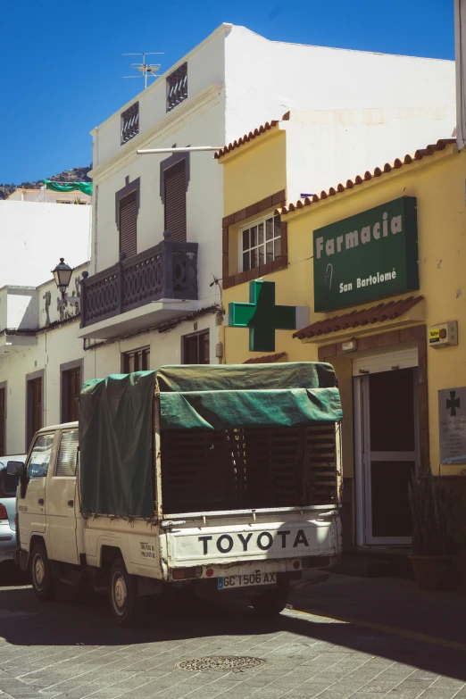 the delivery truck is parked in front of the store