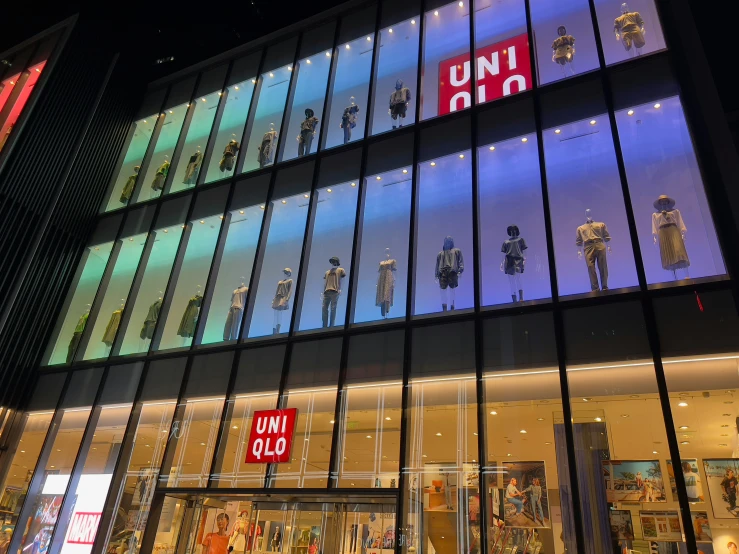 a brightly lit window display is in the front of a large retail store