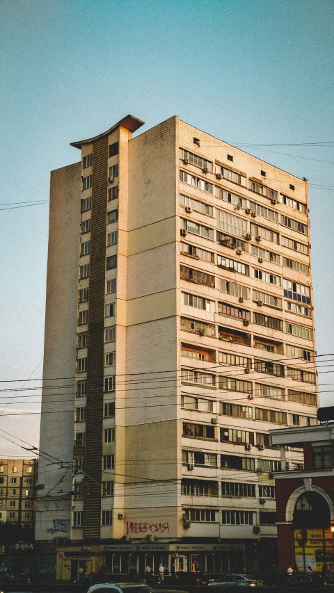 a very tall building with several windows and balconies on top