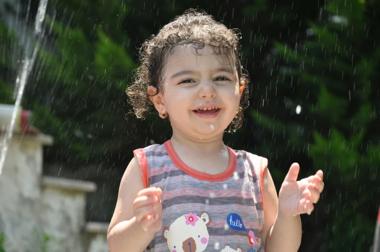 a close up of a child near a fountain