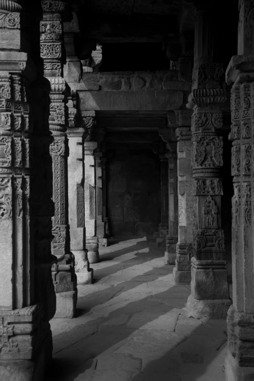 a black and white po of pillars at an indian temple