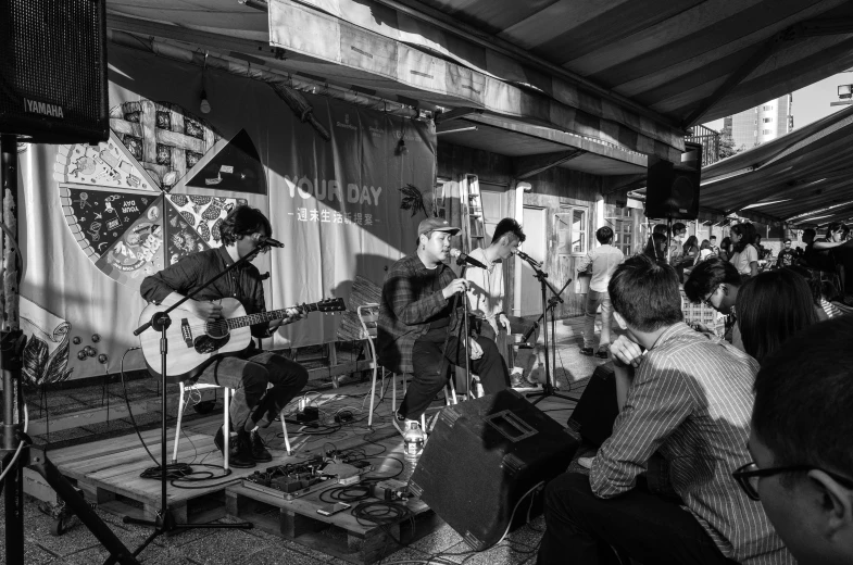 a group of people playing instruments in front of a tent