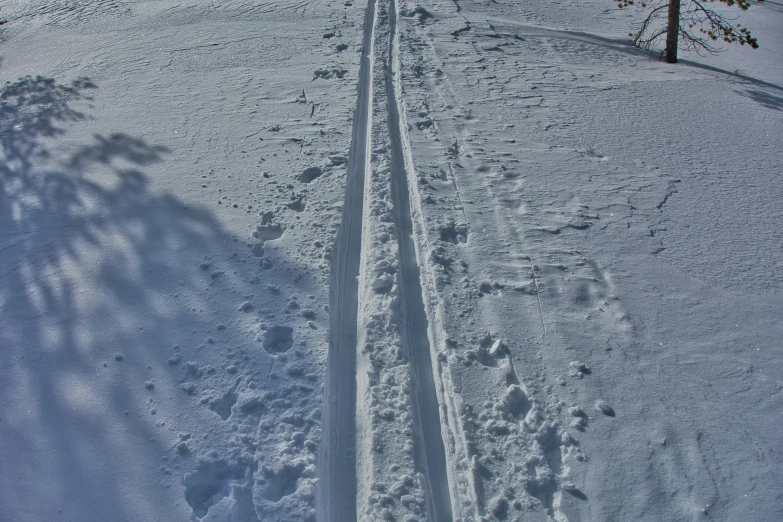 an old trail is next to an empty road