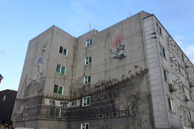 a very tall building with windows and graffiti