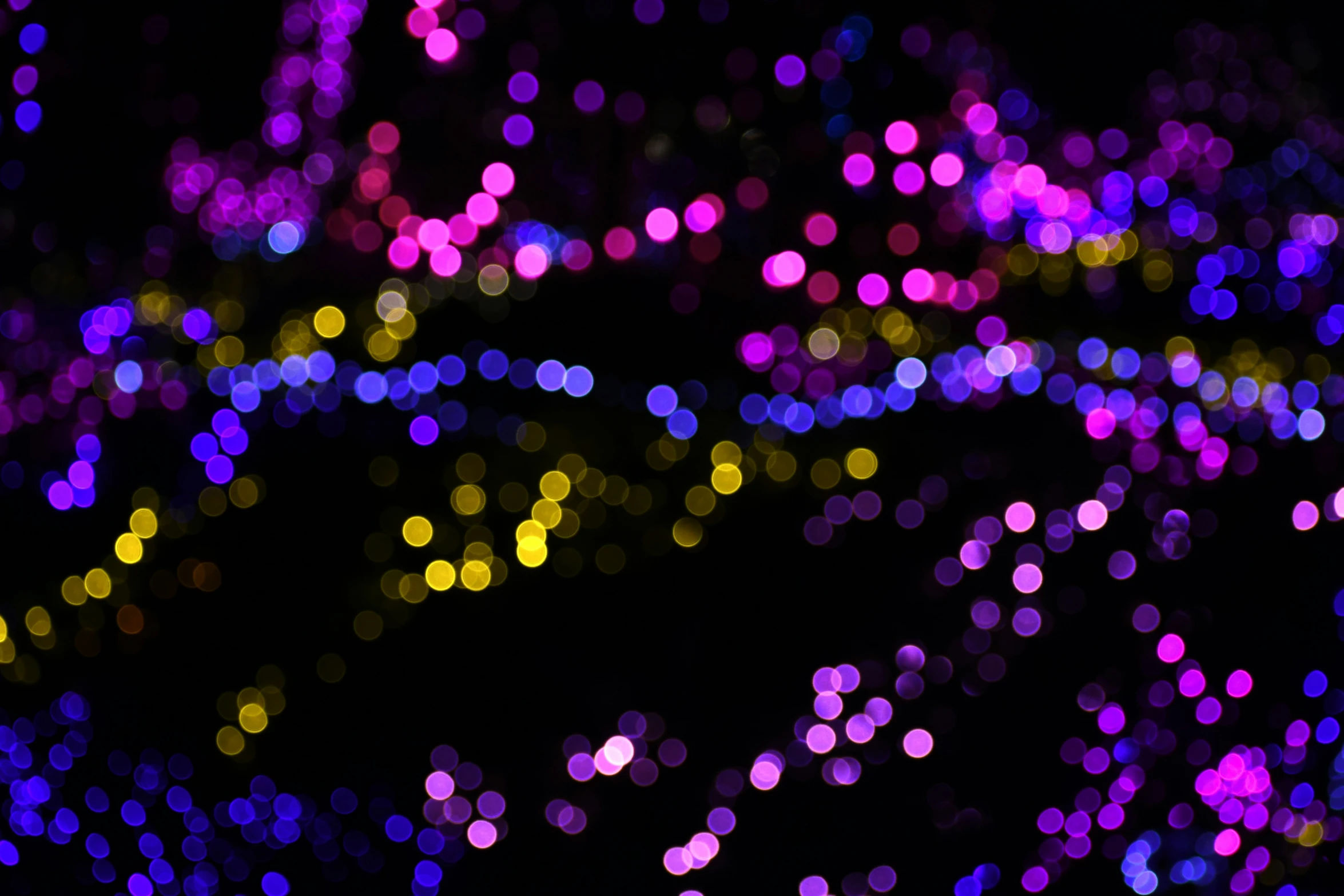 boke of bright lights of different colors, including blue and pink