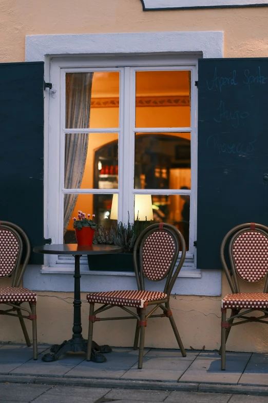 a table and chairs on the side of a street