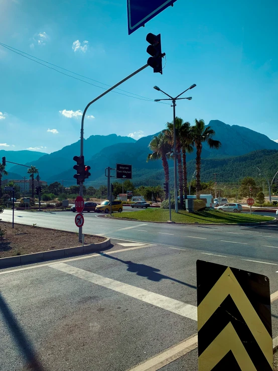 a city intersection at an intersection with mountains in the background