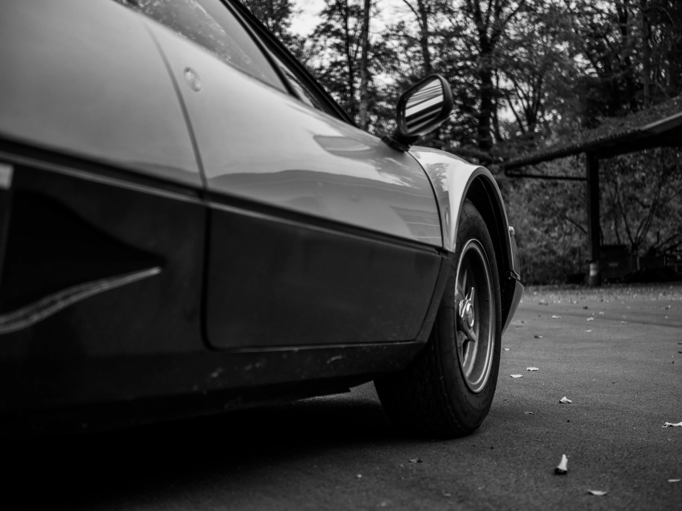 black and white pograph of a car on the street