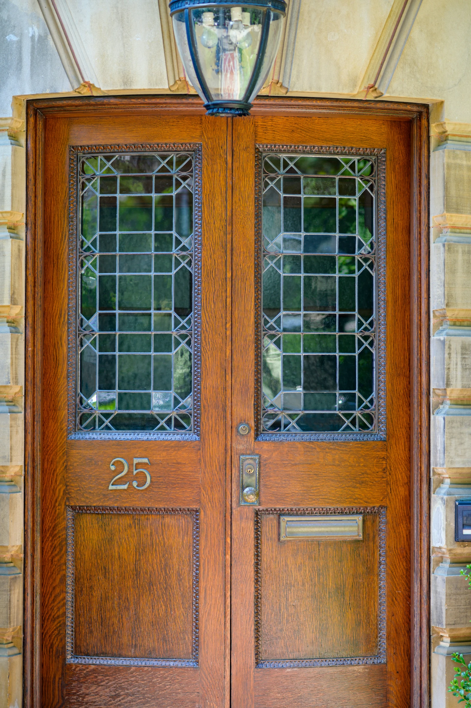 a pair of wood double doors on a stone building