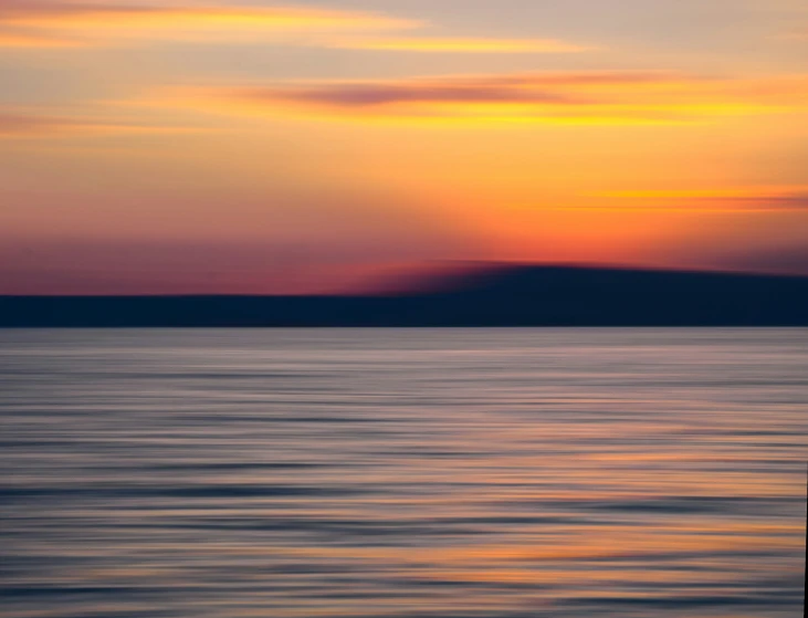 sunset reflecting off the calm waters near an island