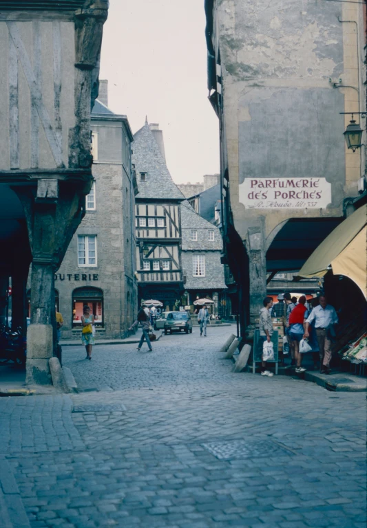 people are on the street in front of many old buildings