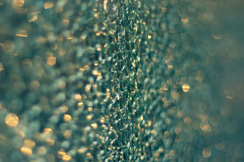 water drops on a window that has green grass behind it