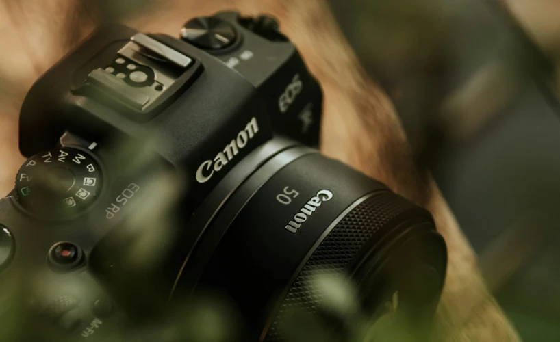 an analog camera sitting on top of a hand