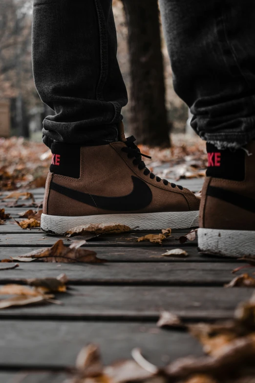 two people are standing on the sidewalk outside wearing sneakers