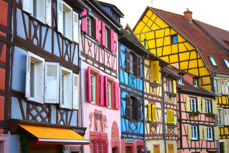 a row of colorful houses along a street in france