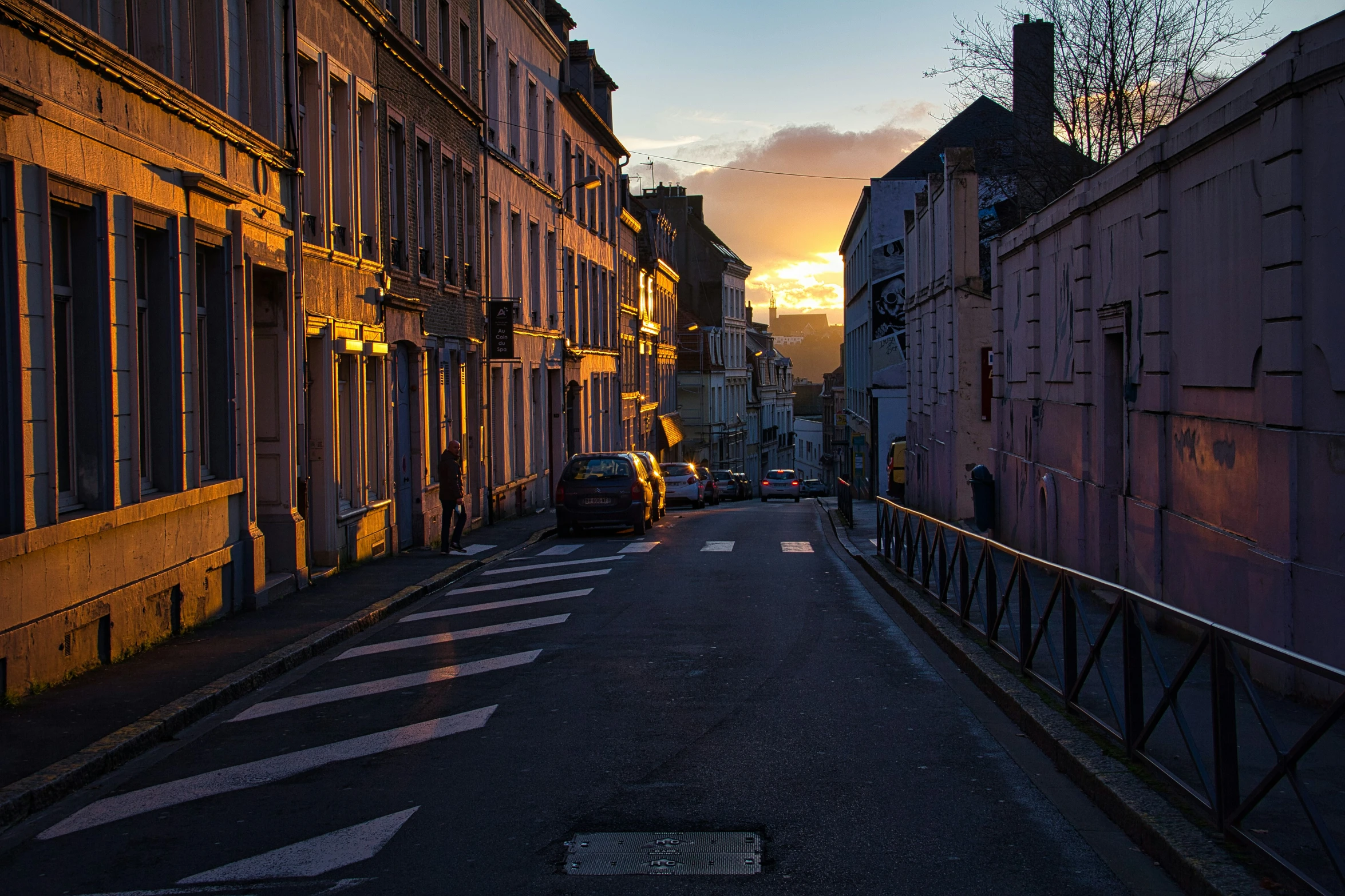 the sun is setting in between two buildings