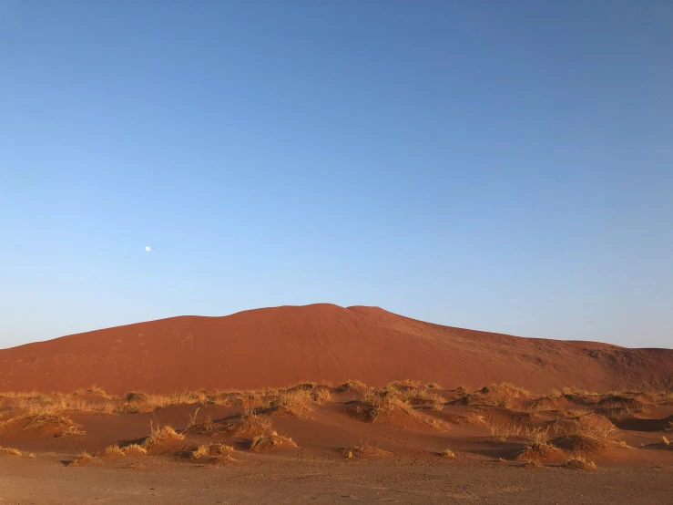 a landscape po of red hills in the desert