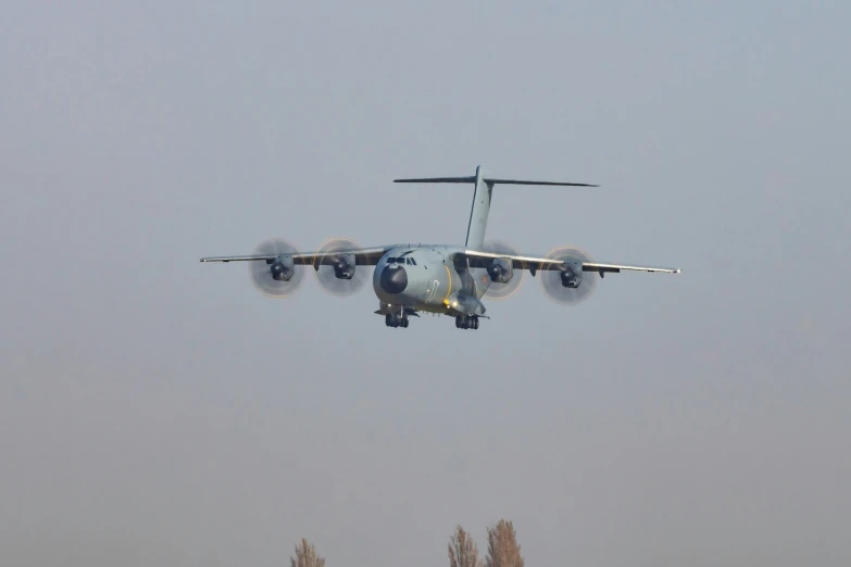 an airplane with three propellers in the air