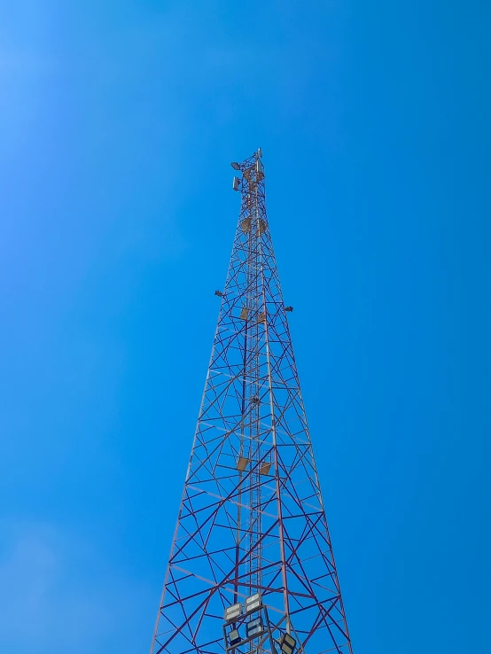 a tower with wires above it on a clear day