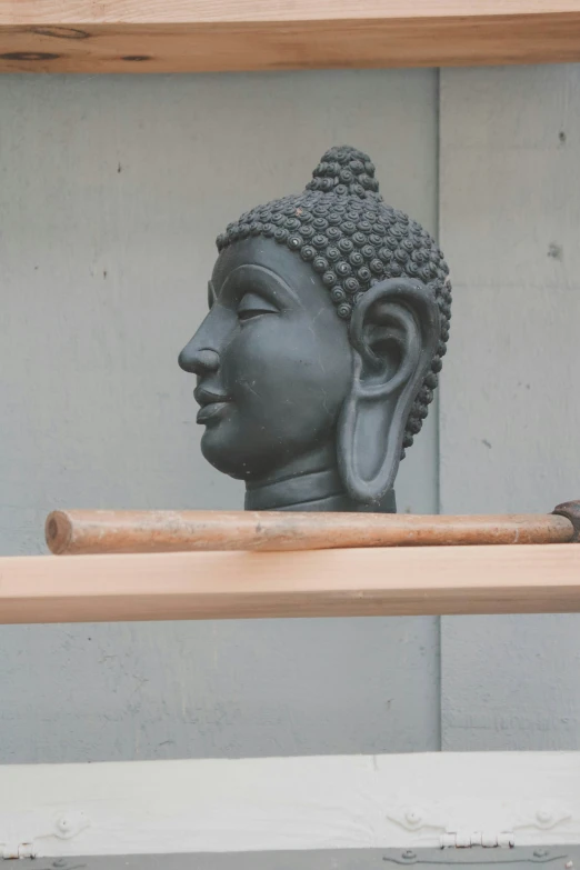 a sculpture of a buddha on the wall