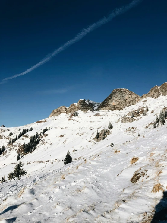 two people are walking up a snowy mountain