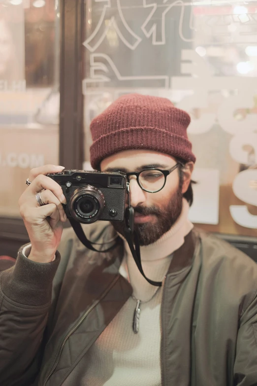 a man taking a picture of himself in a restaurant with a camera