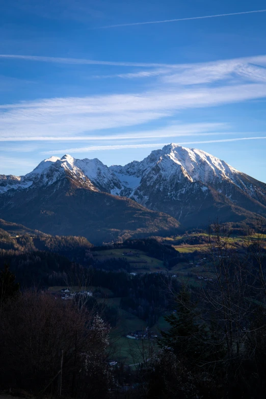 the snow capped mountains are shown under a blue sky