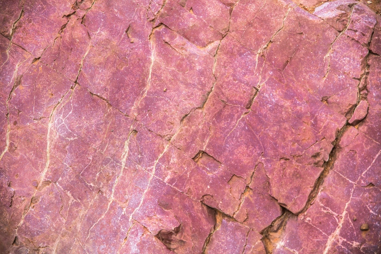 the purple paint is textured over the rocks