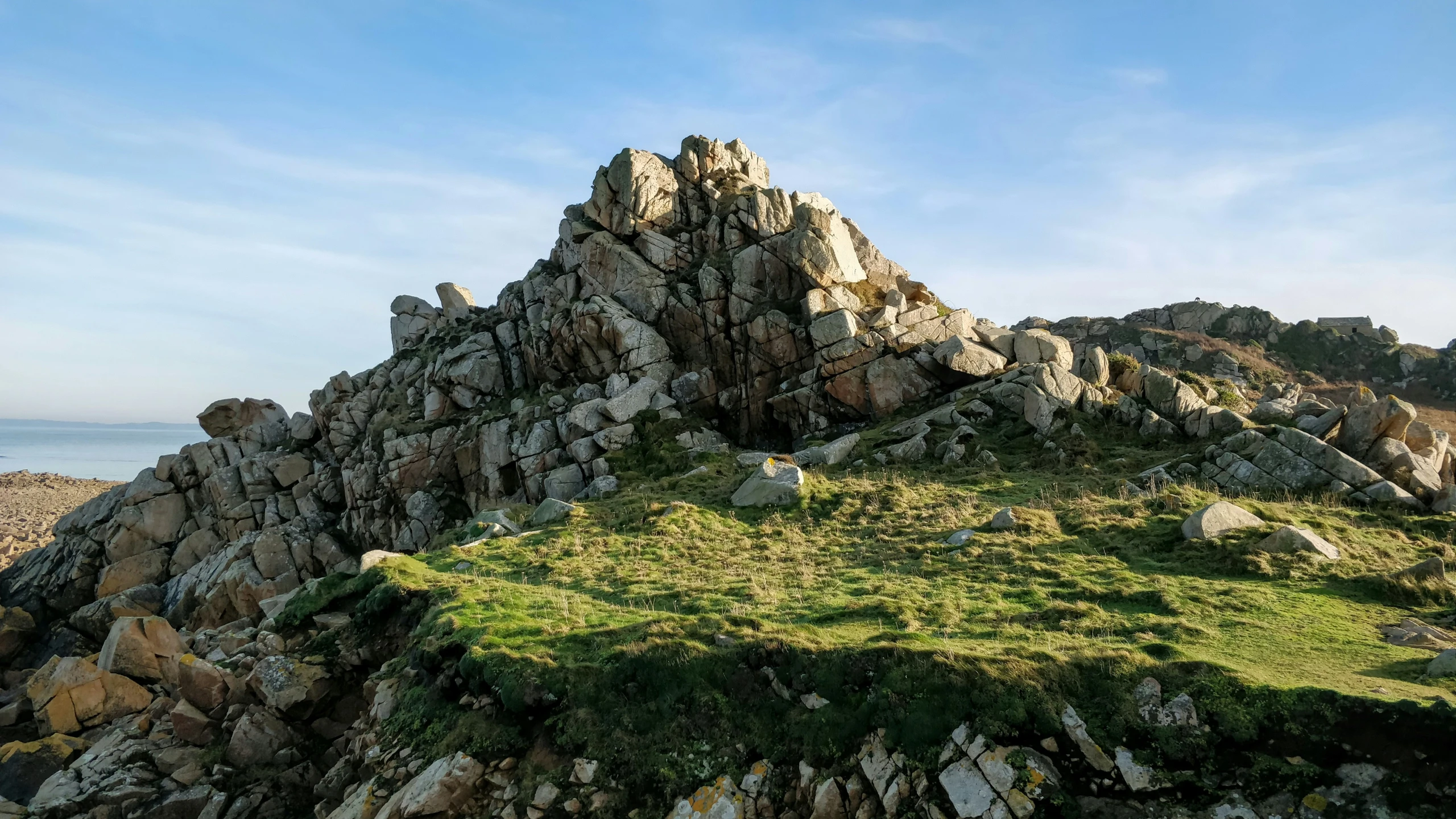 the summit of a large rocky mountain near a lake