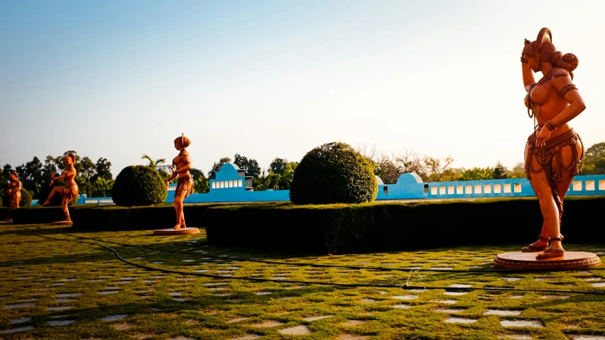 statues of women are shown in a beautiful outdoor setting