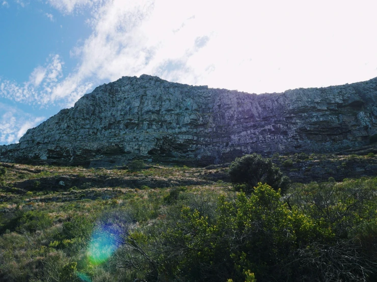 a po of a mountainside with the sun shining