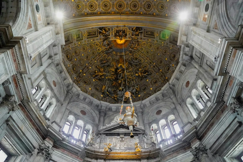 inside an old cathedral with a massive gold dome