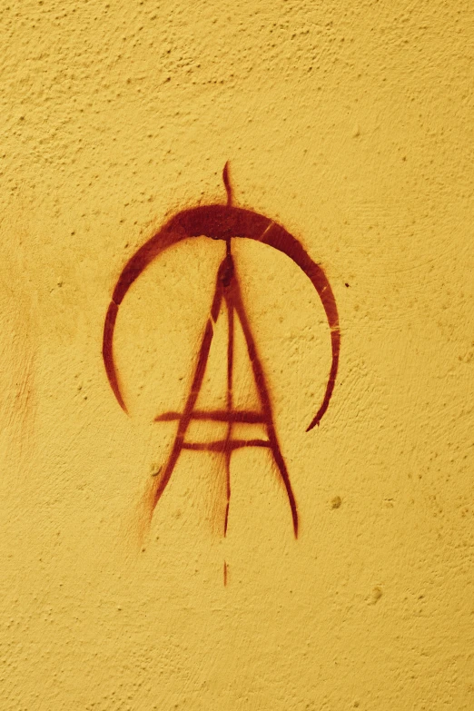 the anarchy symbol is drawn in the sand