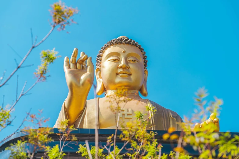 a large buddha statue is shown with its hands up