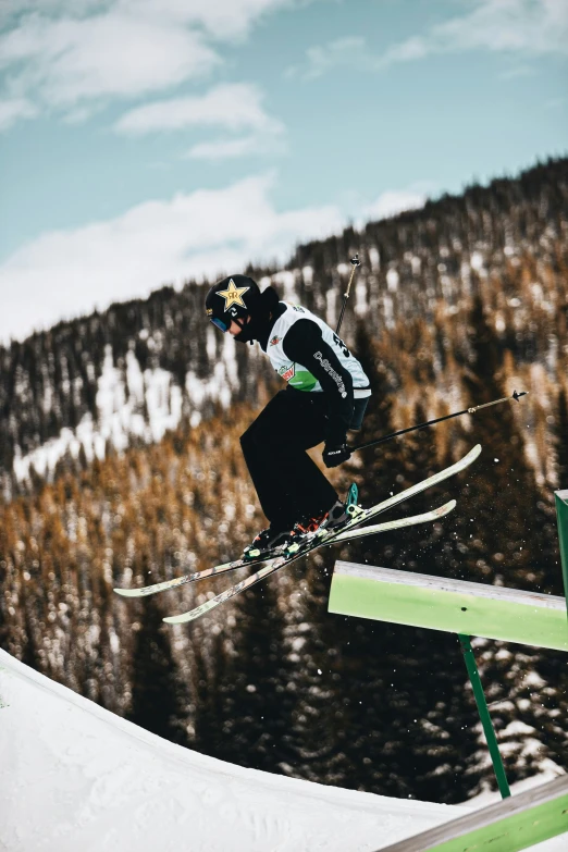 a skier in black is doing tricks on the slope