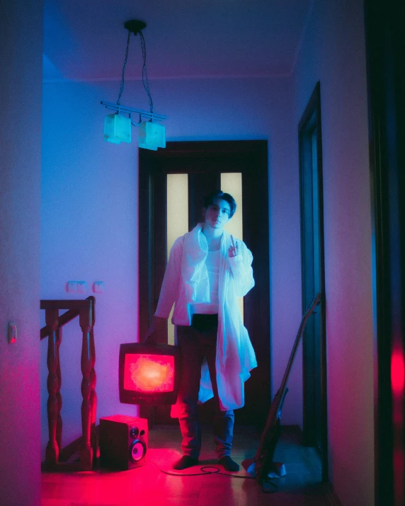 a man standing in a room with an old tv