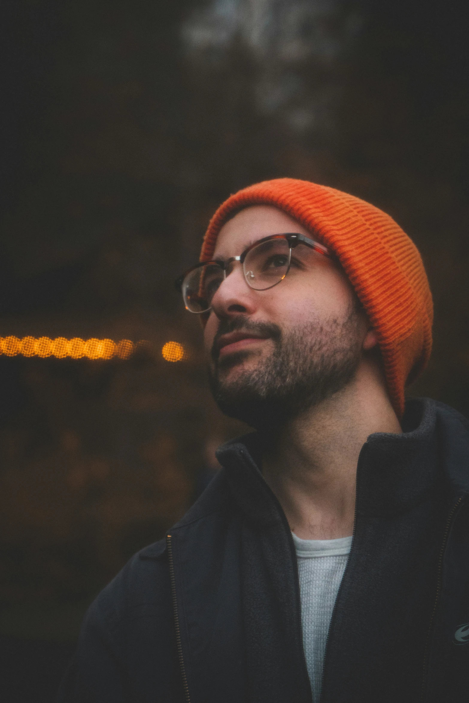 a man with a bright orange knit cap