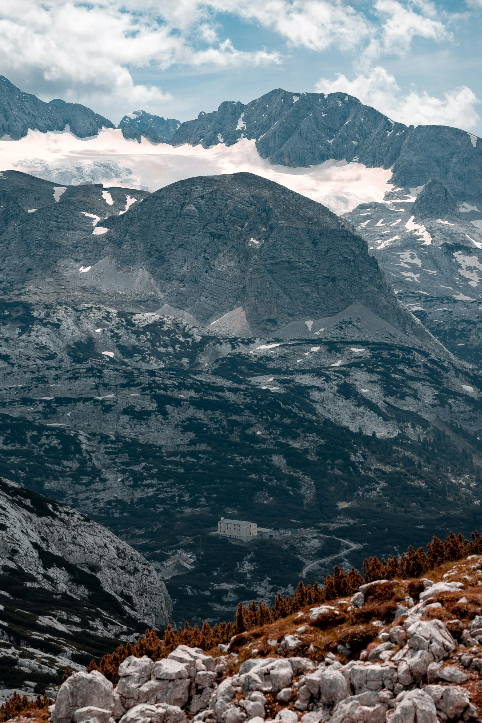 a person with a backpack standing at the top of a mountain