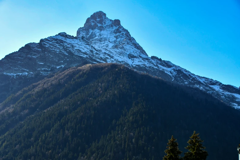 a tall mountain with snow on the top