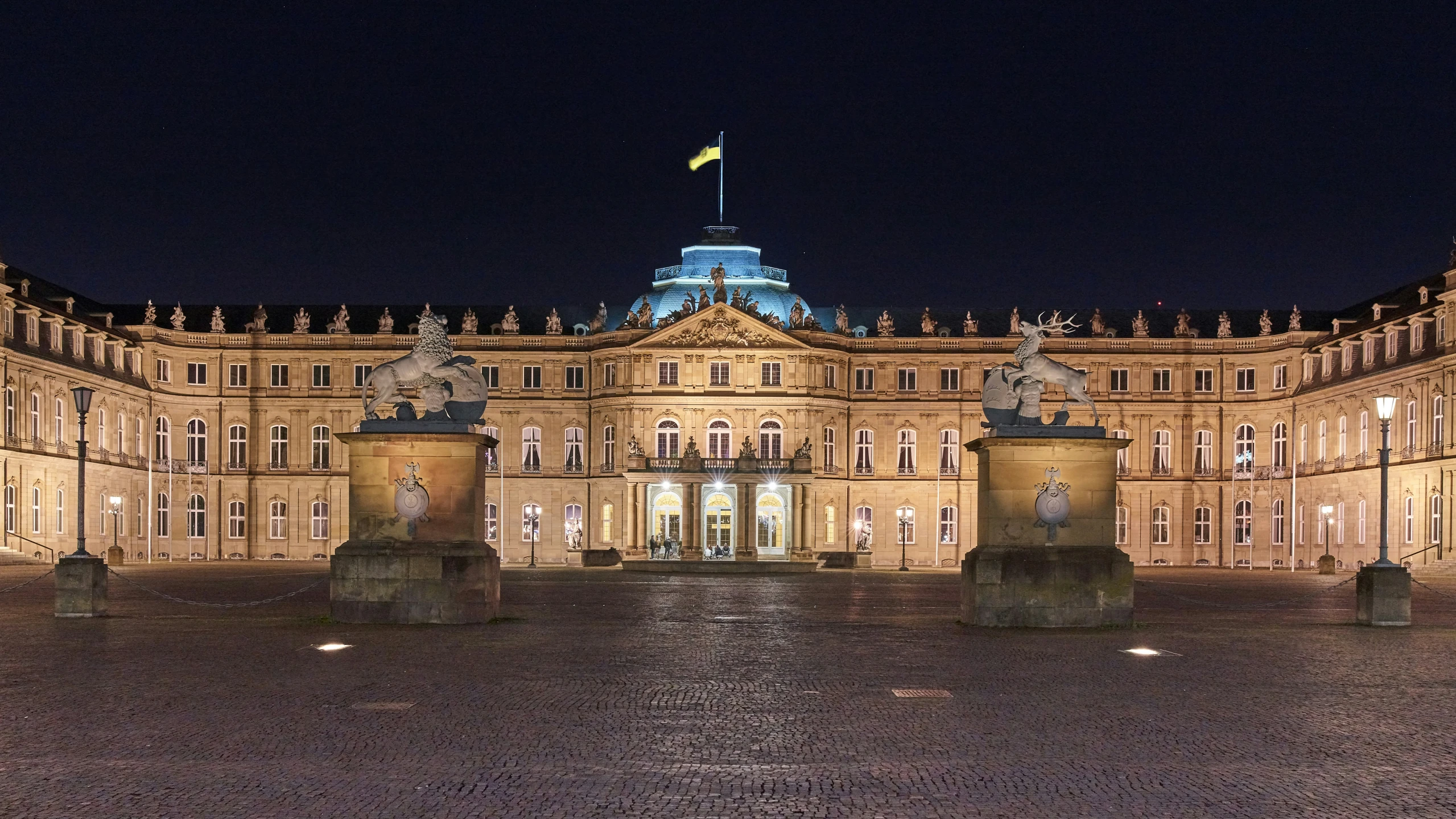 a large stone building has lit up at night