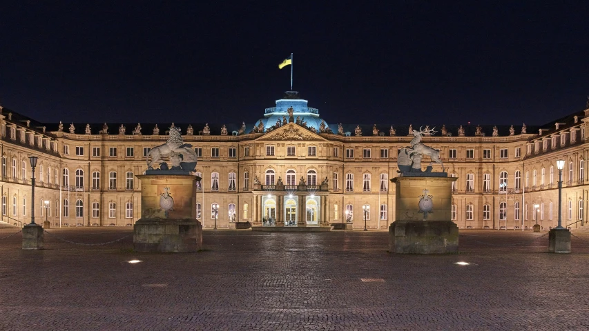 a large stone building has lit up at night