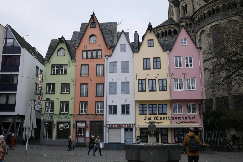 a group of colorful buildings sitting on the side of a road