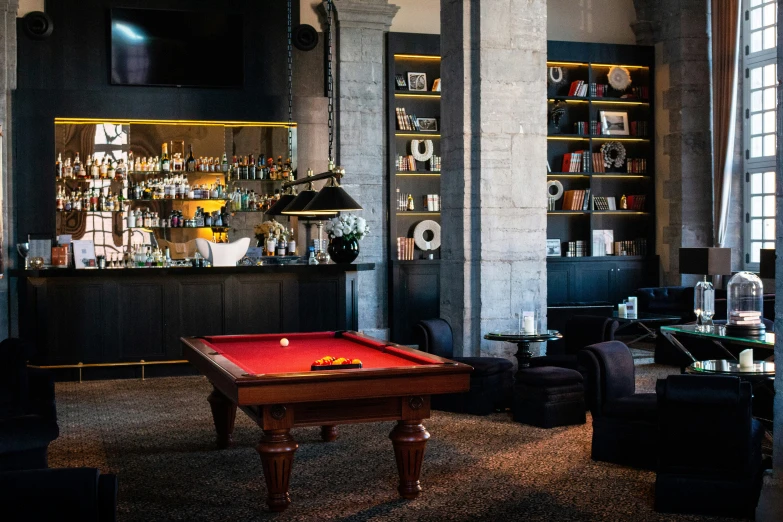 a red pool table sitting in a room