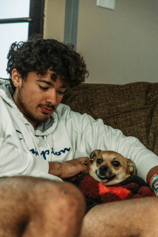 a man holding a dog on his lap