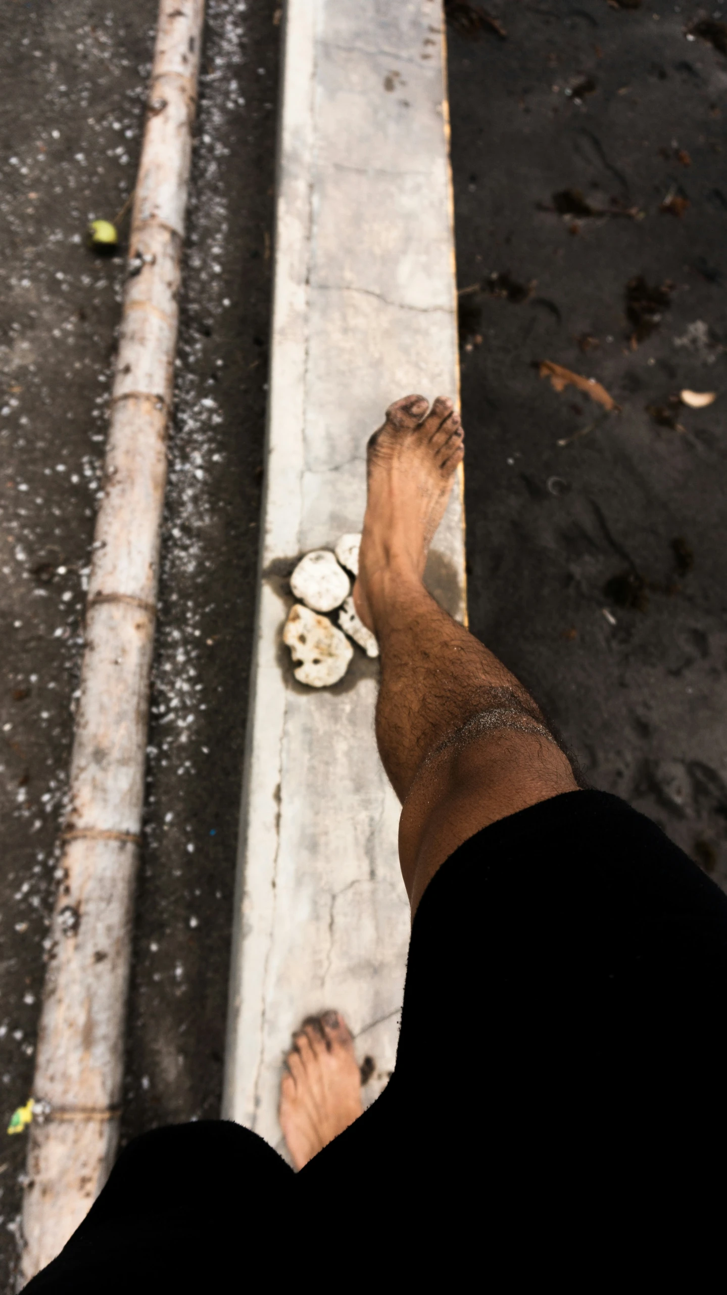 a person with their bare foot near a meter