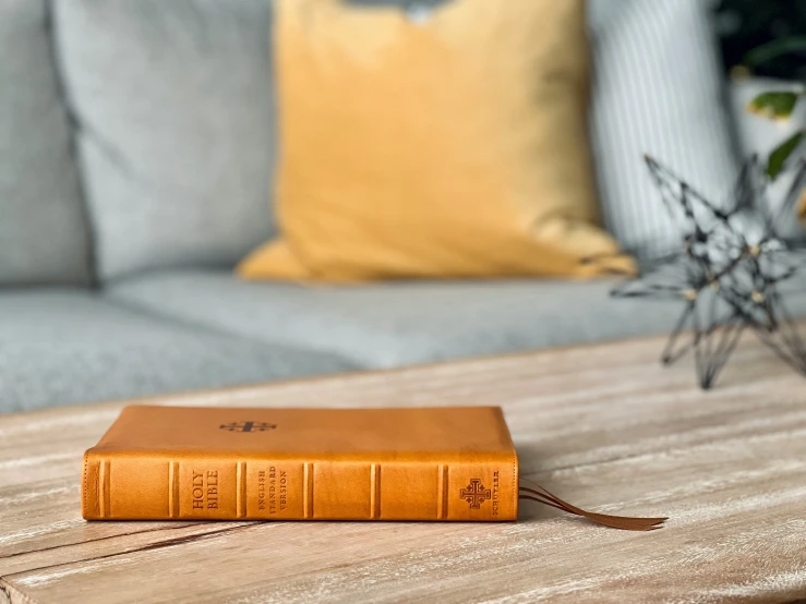 an orange book sitting on top of a wooden table