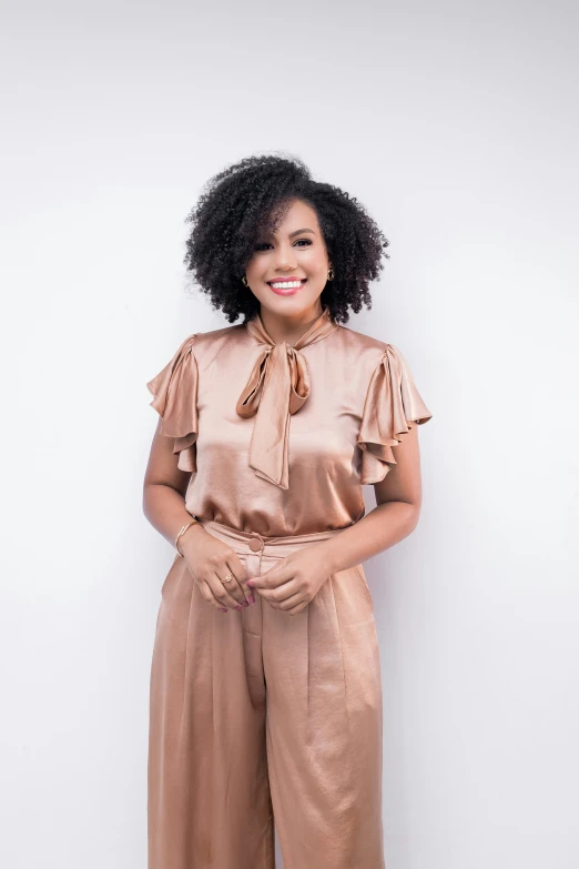 a woman standing in front of a white wall