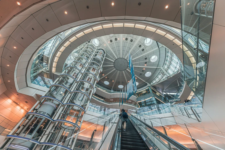 escalator and stairs leading down inside an office building