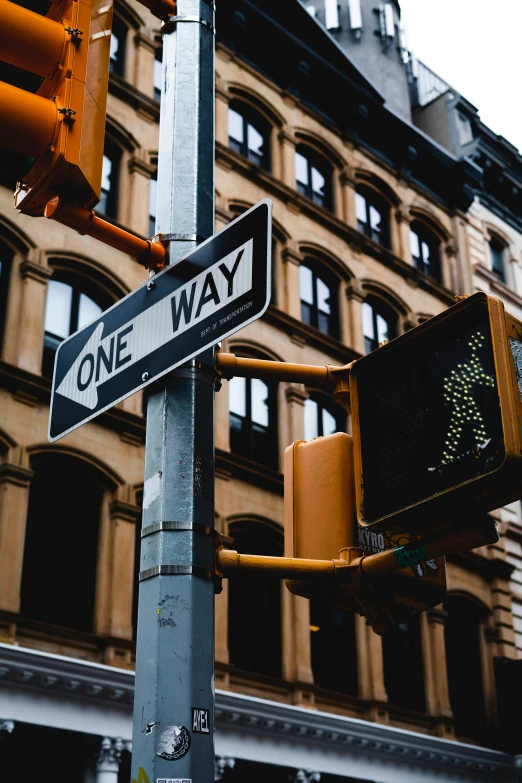 a sign on a street pole in the middle of the city