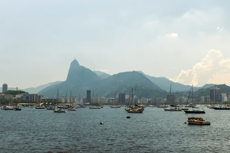 a harbor filled with boats with mountains in the distance